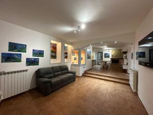 a living room with a couch and paintings on the walls at House gallery in Perugia