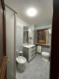 a bathroom with a sink and a toilet at House gallery in Perugia +7 photos