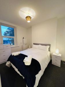 a bedroom with a large white bed and a window at Apartments 7 Greenfield Road in Liverpool