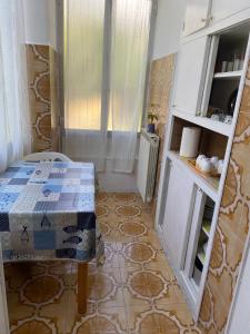 a small room with a table and a kitchen at GELSOMINO in Levanto +2 photos