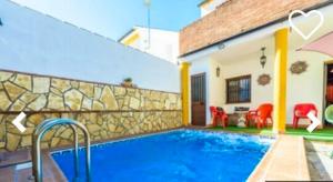 a villa with a swimming pool and a house at 2 bedrooms house with private pool and terrace at El Bosque in El Bosque