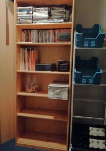 a book shelf filled with lots of dvds at De Strandwandeling 0203 Appartement met frontaal zeezicht in Ostend