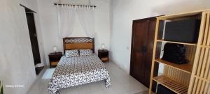 a bedroom with a bed with a black and white comforter at Suite casa rural Los Patios, CONIL in Tías