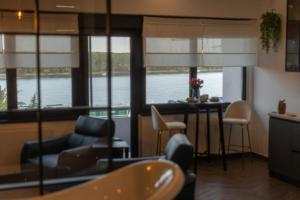 a living room with a view of the water at Studio Apartman Stari Toranj IV in Vukovar