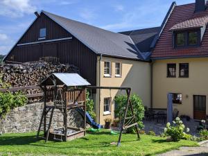 a playground in the yard of a house at Ferienwohnung Aus-Zeit auf dem Lande in Bad Gottleuba