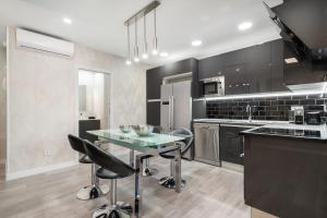 a kitchen with a table and some chairs in it at Plaza España Apartment in Madrid