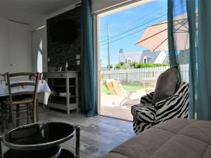 a room with a sliding glass door to a patio at Maison Perros-Guirec, 3 pièces, 4 personnes - FR-1-368-301 in Perros-Guirec