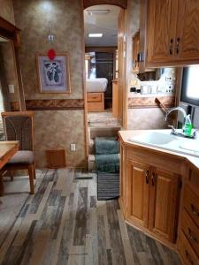 a kitchen with a sink and a kitchen with a bedroom at 40' RV Move in Ready in Jordan