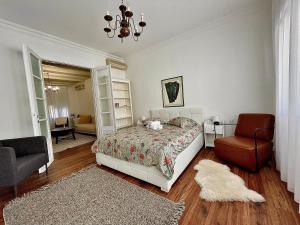 1 dormitorio con 1 cama y 1 silla en Linden Korzo with balcony, en Rijeka