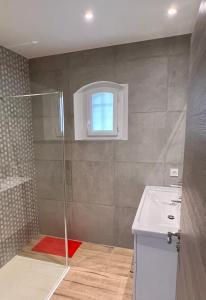 a bathroom with a shower and a sink and a window at Villa Gaudina in Bandol +17 photos