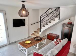 a living room with a couch and a table at Villa Gaudina in Bandol
