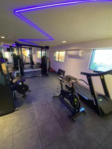 a gym with several treadmills and exercise bikes in a room at Flat ARPOAR Suítes Manaíra com vista para o mar in João Pessoa