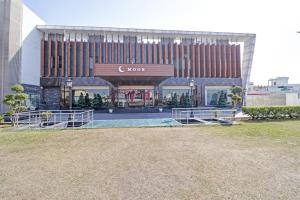 a building with a pool in front of it at Collection O Hotel Moon in Jammu