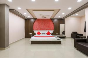 a bedroom with a bed with a red headboard at Collection O Shree Dhoramnath in Nakhtarāna