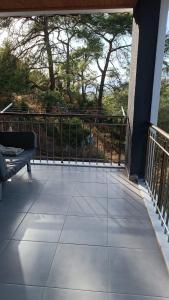 a screened porch with a bench and a railing at House of Joy in Marmaris