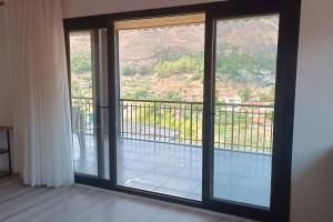 a room with sliding glass doors with a balcony at House of Joy in Marmaris
