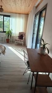 a living room with a table and chairs and windows at House of Joy in Marmaris