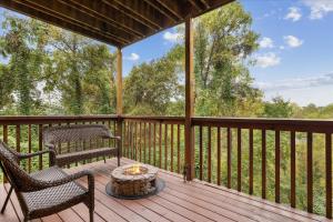a screened in porch with two chairs and a table at Five-Bedroom House in Sevierville