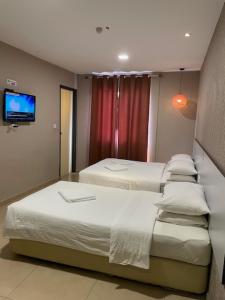 Postel nebo postele na pokoji v ubytování Hotel Jelai @ Temerloh, Pahang