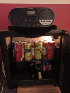a microwave oven with cans of drinks in it at Aes Sedai Kinetic Spa, Living & Airport Shuttle Services in Antwerp