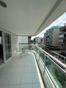 卡波布里奧的住宿－Apartamento 3 Quartos em Frente à Praia do Forte，大楼内的阳台配有桌椅