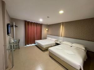 Postel nebo postele na pokoji v ubytování Hotel Jelai @ Temerloh, Pahang