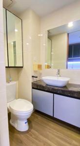 a bathroom with a white toilet and a sink at Nagoya Thamrin City Apartment in Nagoya