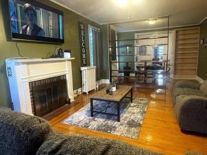 a living room with two couches and a fireplace at Large 2 Bed-Room Apt Across From Union College in Schenectady