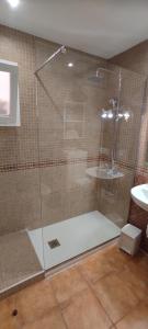 a shower with a glass door in a bathroom at Alojamiento Parque Corralejo in Corralejo