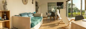 a living room with a couch and a table at Appartement Nature et Mer. in Moëlan-sur-Mer