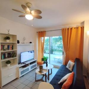 a living room with a blue couch and a tv at Casa Algar - La Calma - big terrace - 4 pools in Playa Flamenca +14 photos