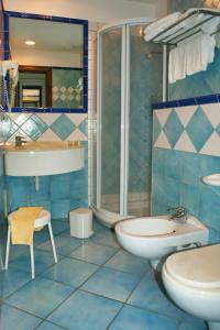 a bathroom with a sink and a toilet and a shower at Villa Ciccio in Ischia