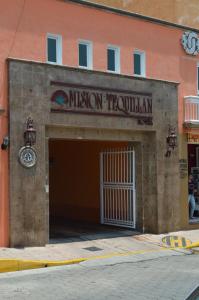 a museum building with a garage with a door at Hotel La Rienda Mision Tequillan in Tequila