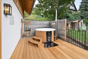 a deck with a hot tub and a bench at Oma Ludwin in Sasbachwalden