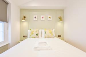 a white bedroom with a large white bed at Star Street Serviced Apartments by Concept Apartments in London