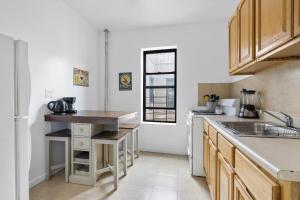 a kitchen with a sink and a counter top at Live Upper Manhattan on a Budget in New York