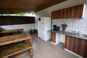 a kitchen with wooden cabinets and a white refrigerator at casa hermosa in Turda