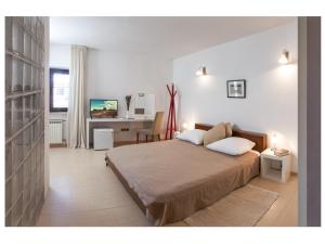 a bedroom with a bed and a desk in it at Apartments Moderno 2 in Fažana