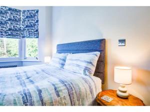 1 dormitorio con 1 cama y 1 lámpara en una mesa en Pass the Keys Stunning house in Leigh, en Southend-on-Sea
