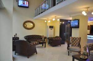 a waiting room with couches and a tv at Gloria Tibi Hotel in Samsun
