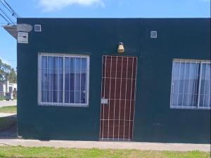 a blue building with two windows and a door at Tu hospedaje soñado in Durazno