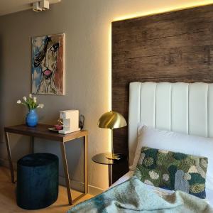 - une chambre avec un lit et une tête de lit en bois dans l'établissement Hotel Battisti 31, à Brescia