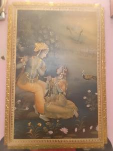 a painting of two women sitting on a boat at lotus Abode in Salem