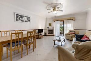 a living room with a table and a dining room at Augusta's House in Cascais