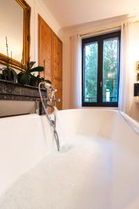 a bathroom with a bath tub with a faucet at Villa The Treport - terrasses & vue mer in Le Tréport