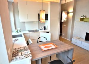 a kitchen with a table and a dining room at Leonardo Walsh Apartment With Lake View in Albisano +13 photos