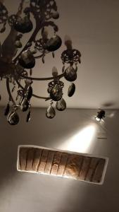 a chandelier hanging from a ceiling with a mirror at Casa Vincenti in Orvieto