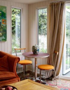 a living room with a table and two chairs at The Garden Room in Knighton