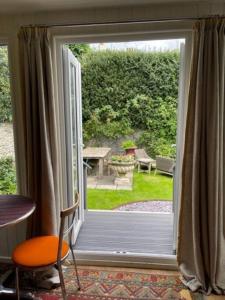 a sliding glass door with a view of a garden at The Garden Room in Knighton