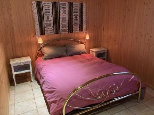 a bedroom with a bed with purple sheets and two tables at Chalet Le Monêtier-les-Bains, 3 pièces, 6 personnes - FR-1-762-25 in Le Monêtier-les-Bains